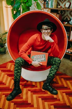 Young adult in festive attire celebrating Christmas with Merry Christmas sign.